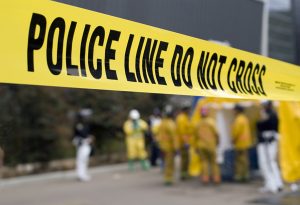 yellow police line with first-responders in background | Hate Crime in Colorado