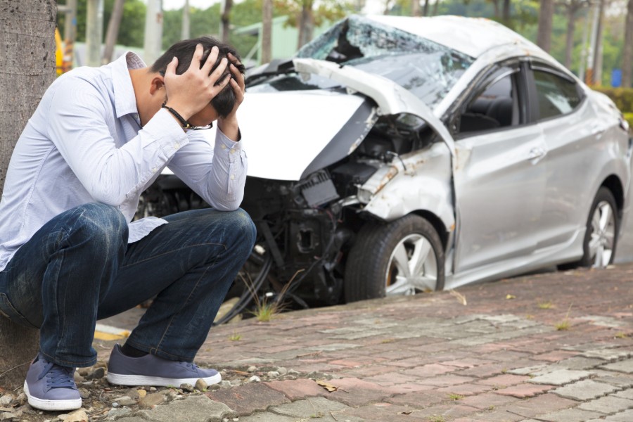 a man in shock beside a damaged car | Drunk Driving becomes Vehicular Homicide